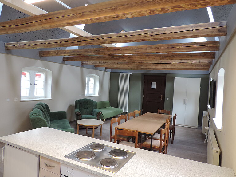 Innenansicht Mehlhaus - Wohnbereich mit Esstisch und Sofas